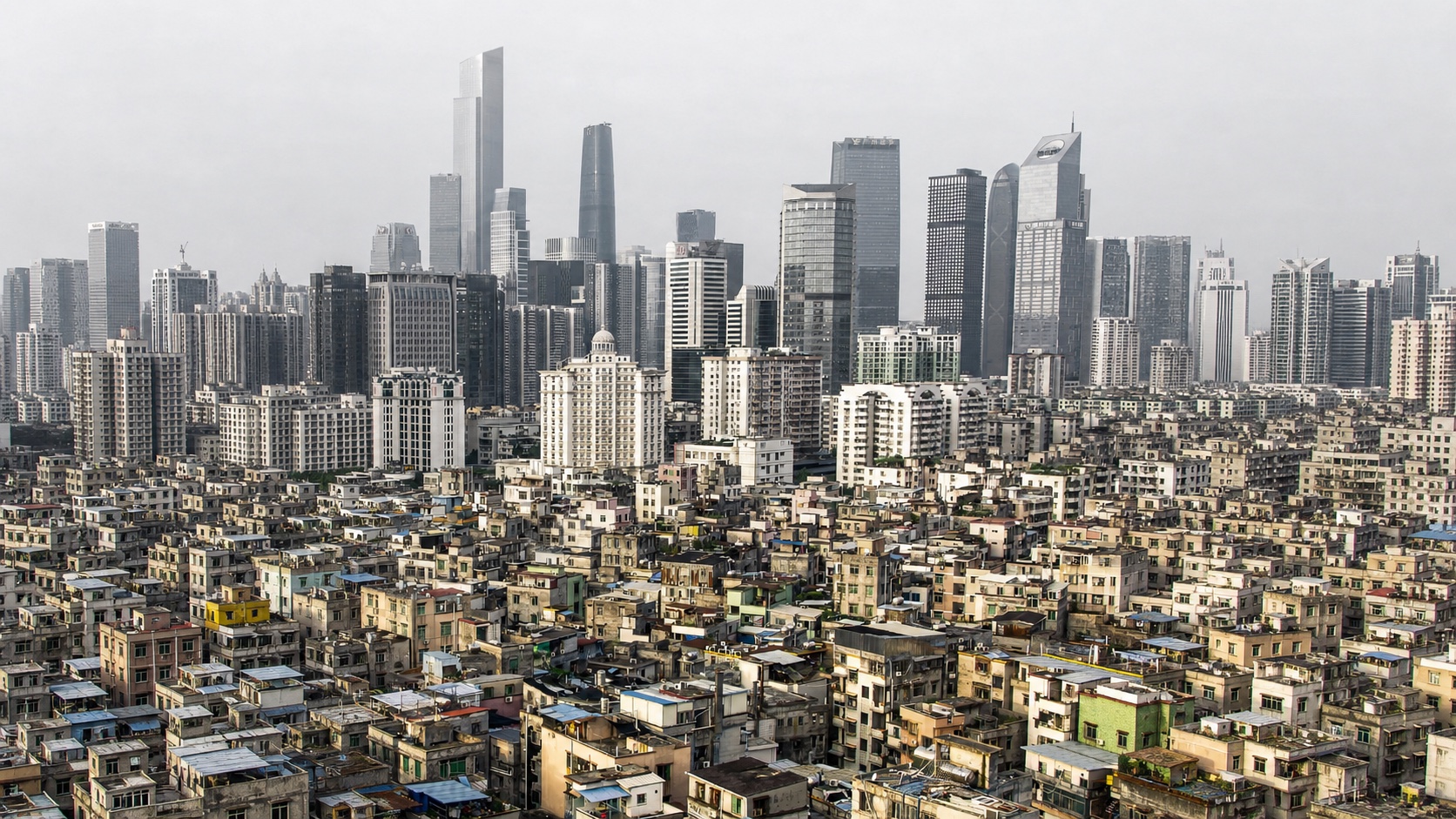 Informal urban village in front of a modern high-rise skyline