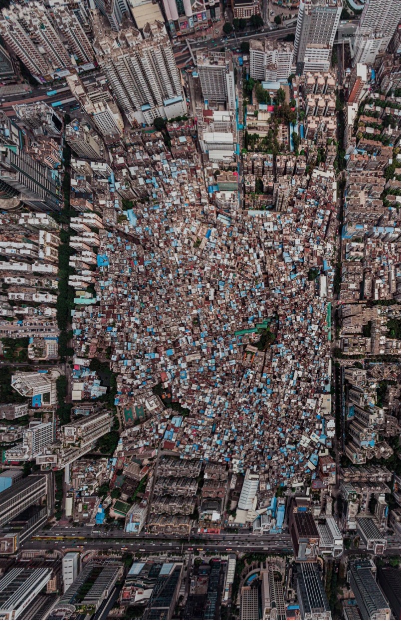 Aerial view of a dense urban village enclosed by formal high-rise development